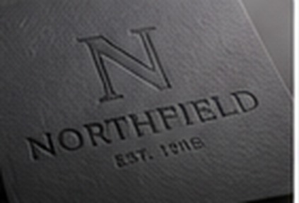 Debossed Northfield lettering on dark card